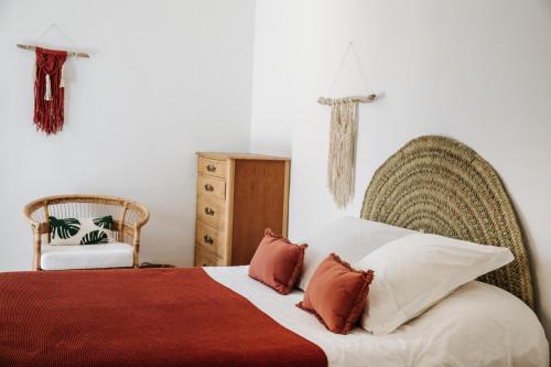 
a bedroom with a bed and a dresser at La Bohemia del Rio Hostal Boutique-Adults Only in Santa Eularia des Riu
