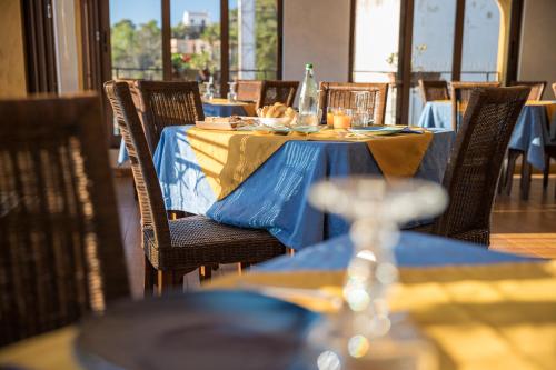 a table with a blue and yellow table cloth on it at Hotel Clelia in Ustica