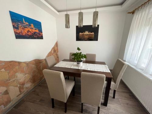 a dining room with a table and chairs at Vámos Apartman in Bük