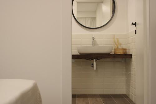 a bathroom with a sink and a mirror at Venere B&B Castelmola in Castelmola