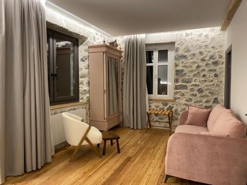 a living room with a couch and a chair at Hotel Arimune in Bakio