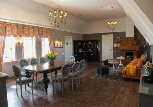 a living room with a dining room table and chairs at Vienkiemis in Kretinga