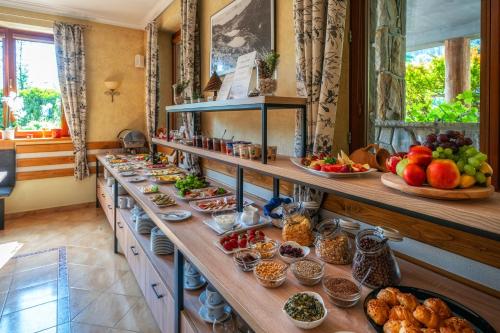 a buffet line with many different types of food at Hotel Eco Tatry Holiday& Spa in Kościelisko