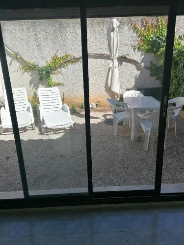 a view of a patio with chairs and a table at La Thérésita in Six-Fours-les-Plages
