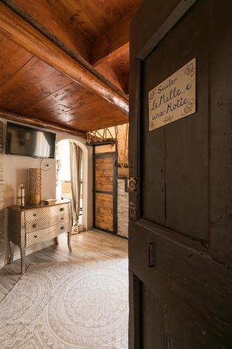 a room with a door with a sign on it at Opera Suites - Le mille e una notte in Calcata