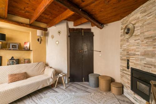 a living room with a couch and a fireplace at Opera Suites - Le mille e una notte in Calcata