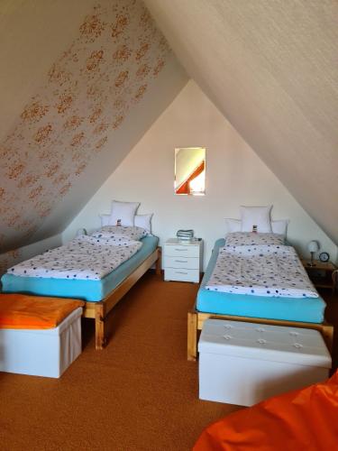 a attic room with two twin beds in it at Ferienwohnung Haus Fischer in Langwedel