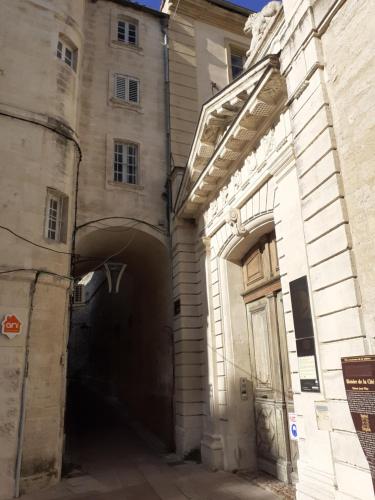 an alley in a building with a tunnel at Studio de l'Horloge - Studio de Charme, hyper centre Maison Jean Vilar in Avignon