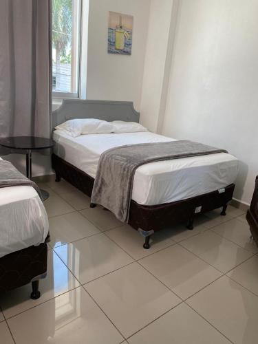 Ένα ή περισσότερα κρεβάτια σε δωμάτιο στο Micro Hotel Rio de Piedras