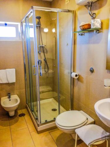 a bathroom with a shower and a toilet and a sink at Hotel Villa Fiorita in Sorrento