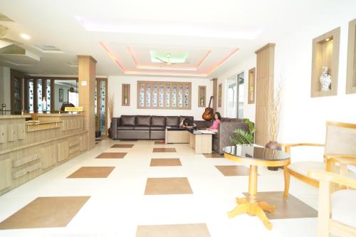 a living room with a couch and a table at North Centre in Cochin