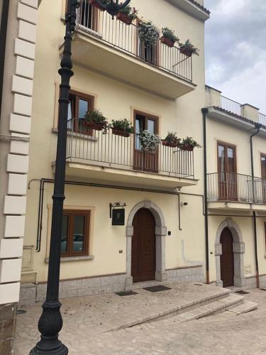 a building with flower boxes on the balconies and a street light at b&b Antiche Dimore Taurasi in Taurasi