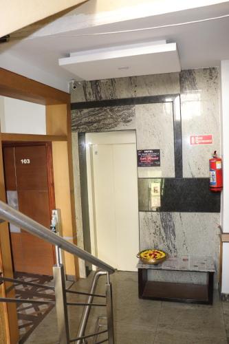 a room with a staircase with a pizza on a table at HOTEL SRI VAARI RESIDENCY in Hosūr