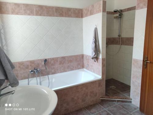 a bathroom with a tub and a sink at Casa Vacanza Riviera dei Saraceni in Trebisacce