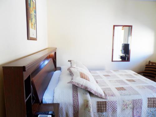 a bedroom with a bed with two pillows on it at Petit Rivera Hotel in Rivera