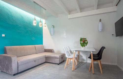 a living room with a couch and a table at DOMKI - Kaszuby Resort ZACISZE - new cottage in Chmielno