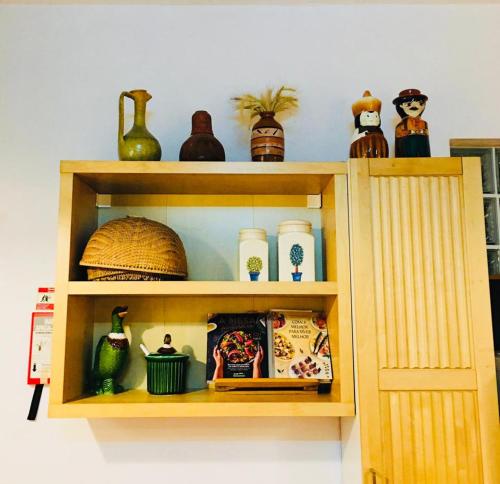 a wooden shelf with vases and other items on it at Monte Ramos in Ferreira do Alentejo