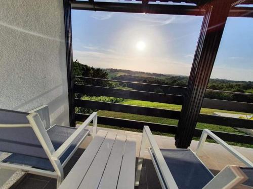 a pair of chairs and a table on a balcony at Holiday Home Nirvana in Gornji Mihaljevec
