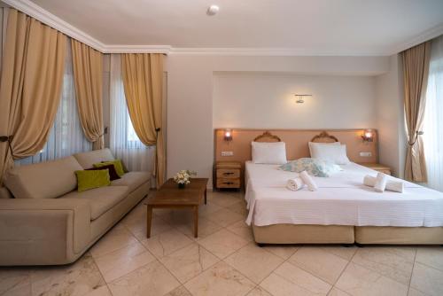 a hotel room with a bed and a couch at B&B Boutique Hotel in Dalyan