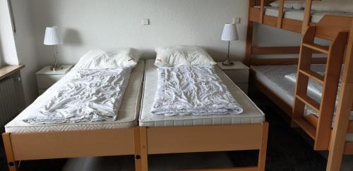two beds in a room with two bunk beds at Haus am Sonnenberg,Todtnauberg, Ferienwohnung 105, direkt am Skilift-Skipiste, Nähe Feldberg in Todtnauberg