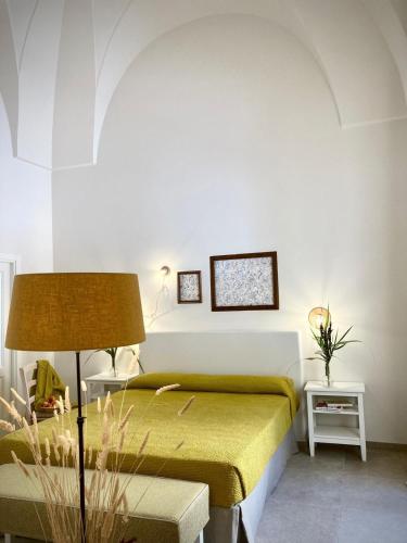 a bedroom with a bed and a table with a lamp at Villa Ricciardi-Suite famigliare 1-zona Ostuni in Montalbano
