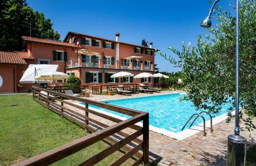 a house with a swimming pool next to a house at Relais Villa Isabel in Pietrasanta