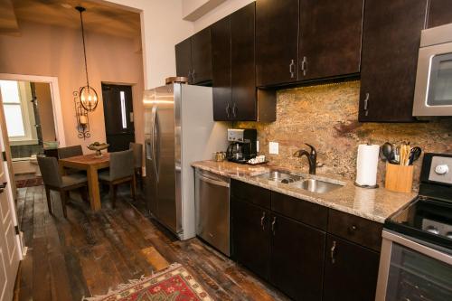 a kitchen with a stainless steel refrigerator and a table at The Windsor - Asheville in Asheville