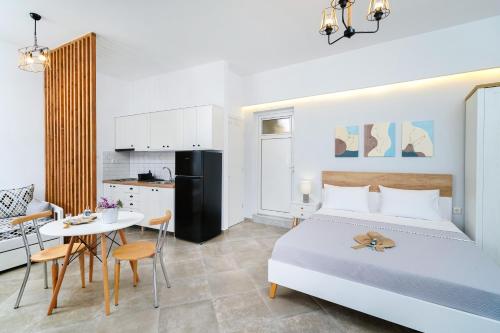 Cet appartement comprend une chambre avec un lit et une table ainsi qu'une cuisine. dans l'établissement Jennifer Studios, à Chrysi Ammoudia