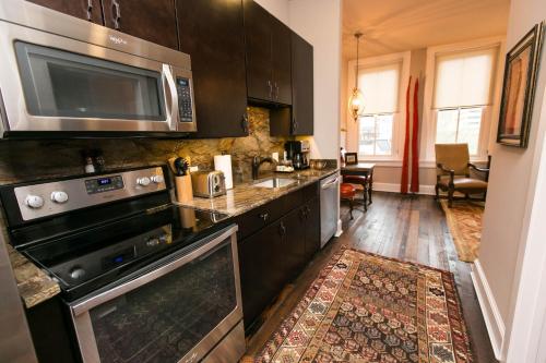 a kitchen with a stove and a microwave at The Windsor - Asheville in Asheville