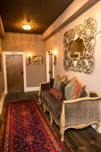 a living room with a couch and a mirror at The Windsor - Asheville in Asheville