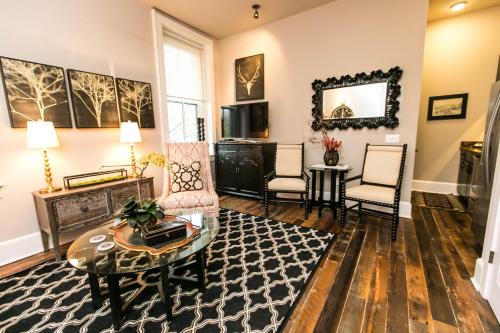 a living room with a table and chairs at The Windsor - Asheville in Asheville