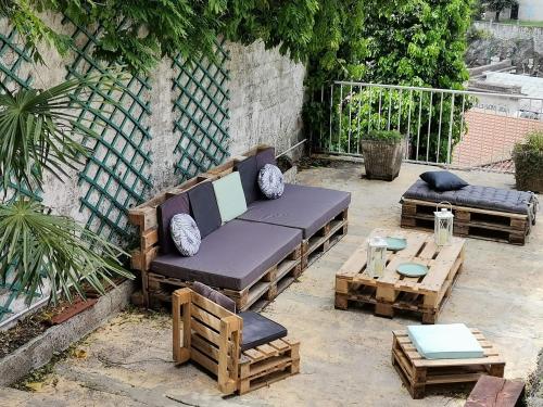 a patio with a couch and a coffee table at La Dolce Vita Lucie in Vals-les-Bains