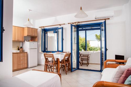 a kitchen and living room with a table and chairs at Kanellis Studios in Avlemonas