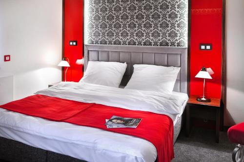a bedroom with a bed with a red head board at Apartament Podwale in Łańcut