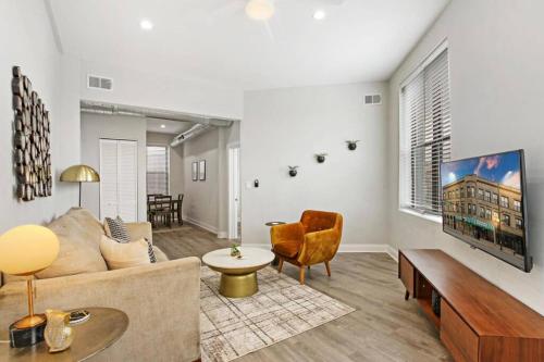 a living room with a couch and a table at 3BR Apt in Logan Square Walkable to Highlights - Central Park S6 in Chicago
