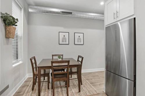 a dining room with a table and a refrigerator at 3BR Apt in Logan Square Walkable to Highlights - Central Park S6 in Chicago