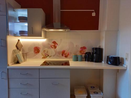 a kitchen with white cabinets and a counter top at Ferienwohnung Xenia in Pirna