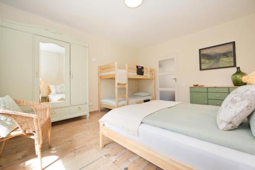 a bedroom with a bed and a chair and a mirror at Apartament Nieoczywisty in Stronie Śląskie