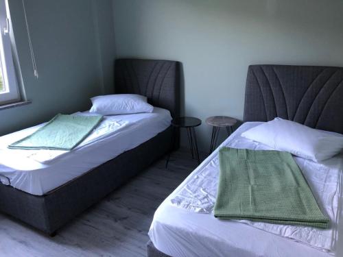 two beds sitting next to each other in a bedroom at Sea and Natural Adalet Suits in Trabzon