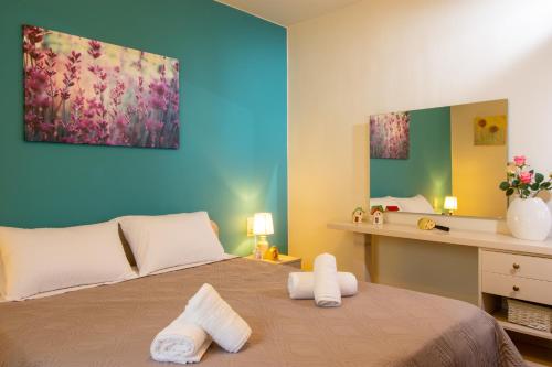 a bedroom with a bed with two towels on it at Eleni's Cozy House in Agios Nikolaos