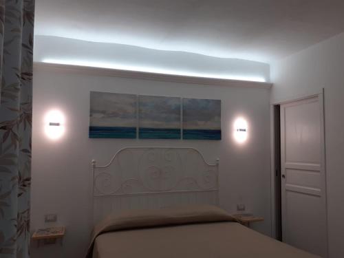 a bedroom with a bed with two lights on it at Le Maioliche in Vasto