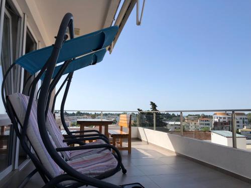 a balcony with chairs and a table on a balcony at Apartments FourRoses in Ulcinj
