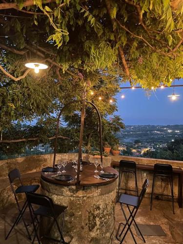 a table and chairs on a patio with a view at Il noceto dell'Etna in Giarre