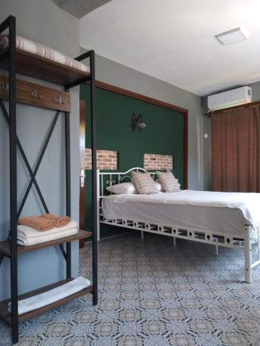 a bedroom with two bunk beds and a green wall at Casa Magnolia Boutique Rooms in Kuşadası