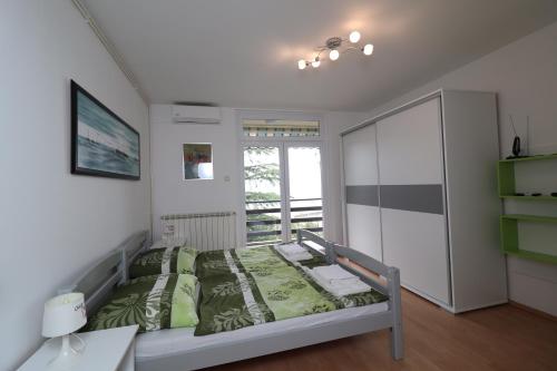 a small bedroom with a bed and a desk at Apartment Gea in Opatija