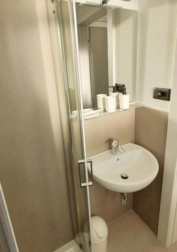 a bathroom with a sink and a shower with a mirror at Affittacamere L'Orto dei nonni in Levanto