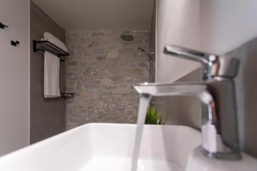 a bathroom with a white sink and a shower at Damari Luxury Retreat Villas Skiathos in Skiathos Town