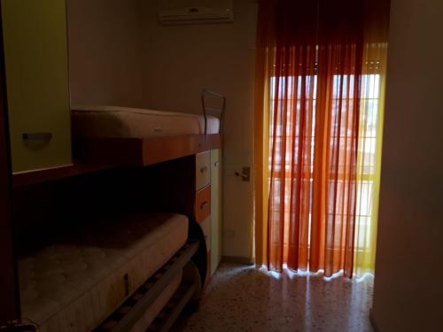 a bedroom with two bunk beds and a window at Casa Anna in Agropoli