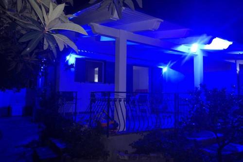 a house at night with blue lights on it at Villa Cilento Mare, bellissima con ampio giardino in Capitello