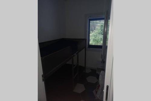 a room with a desk and a window at Villa Cilento Mare, bellissima con ampio giardino in Capitello
